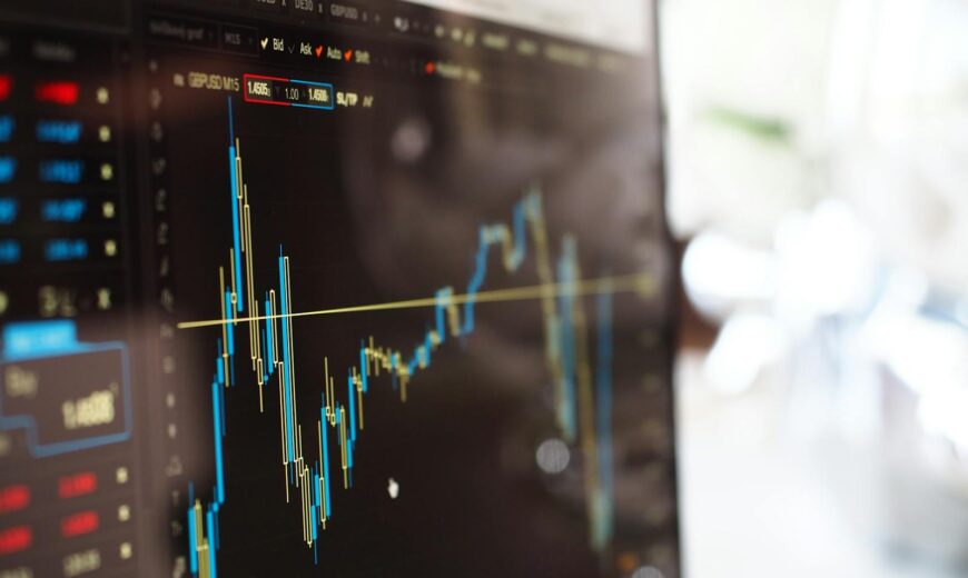 Detailed view of financial trading graphs on a monitor, illustrating stock market trends.